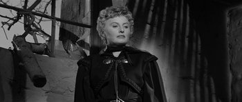 Movie still from “Forty Guns” (1957), directed by Samuel Fuller – An old photo of a woman in a black dress; Close Up shot, Low angle