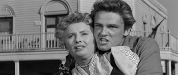 Movie still from “Forty Guns” (1957), directed by Samuel Fuller – An old photo of a man and a woman; Close Up shot, Low angle