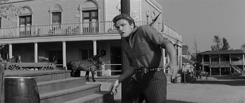 Movie still from “Forty Guns” (1957), directed by Samuel Fuller – A black and white photo of a man and a horse; Medium shot, Low angle