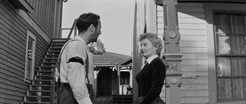 Movie still from “Forty Guns” (1957), directed by Samuel Fuller – A man and a woman standing next to each other; Medium shot, Low angle