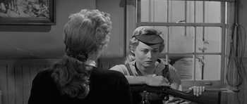 Movie still from “Forty Guns” (1957), directed by Samuel Fuller – An old photo of a woman looking in the mirror; Medium shot, Over the shoulder angle