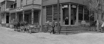 Movie still from “Forty Guns” (1957), directed by Samuel Fuller – An old photo of a man walking down the street; Extreme Wide shot, High angle