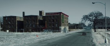 Movie still from “Four Brothers” (2005), directed by John Singleton – An empty street with a building in the background; Extreme Wide shot, High angle