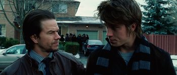 Movie still from “Four Brothers” (2005), directed by John Singleton – Two men standing next to each other in front of a house; Close Up shot, Over the shoulder angle
