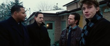 Movie still from “Four Brothers” (2005), directed by John Singleton – Two men standing in front of a brick building; Medium shot, Over the shoulder angle