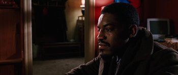 Movie still from “Four Brothers” (2005), directed by John Singleton – A man sitting in front of a mirror in a dark room; Close Up shot, Over the shoulder angle