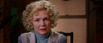 Movie still from “Four Brothers” (2005), directed by John Singleton – An older woman sitting in a chair looking at the camera; Close Up shot, Over the shoulder angle