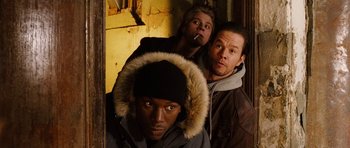 Movie still from “Four Brothers” (2005), directed by John Singleton – A group of men standing next to each other in a room; Medium shot, Low angle