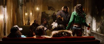 Movie still from “Four Brothers” (2005), directed by John Singleton – A group of people sitting in a living room; Medium shot, Over the shoulder angle