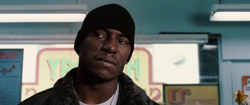 Movie still from “Four Brothers” (2005), directed by John Singleton – A person wearing a hat; Close Up shot, Low angle