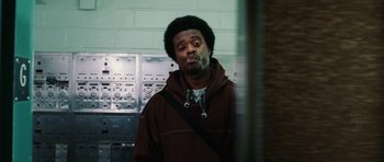 Movie still from “Four Brothers” (2005), directed by John Singleton – A man in a brown jacket is standing in a room; Close Up shot, Low angle