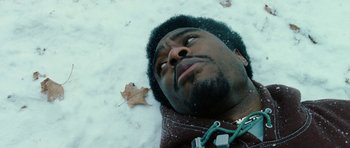 Movie still from “Four Brothers” (2005), directed by John Singleton – A person laying in the snow; Close Up shot, Overhead angle