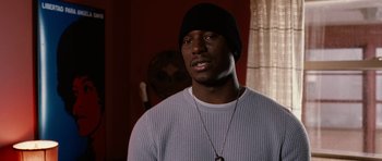Movie still from “Four Brothers” (2005), directed by John Singleton – A man wearing a black hat and a white sweater; Close Up shot, Over the shoulder angle