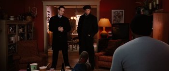 Movie still from “Four Brothers” (2005), directed by John Singleton – Two men standing in a living room next to each other; Medium shot, Over the shoulder angle