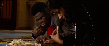 Movie still from “Four Brothers” (2005), directed by John Singleton – A man and a woman sitting at a table eating food; Close Up shot, High angle