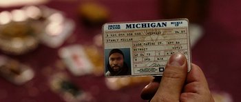 Movie still from “Four Brothers” (2005), directed by John Singleton – A person holding a driver's license in their left hand; Extreme Close Up shot, Over the shoulder angle