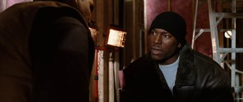 Movie still from “Four Brothers” (2005), directed by John Singleton – A man wearing a black jacket and a black hat; Close Up shot, Over the shoulder angle