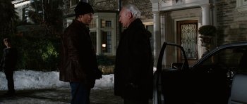 Movie still from “Four Brothers” (2005), directed by John Singleton – Two men standing next to each other on the sidewalk; Medium shot, Over the shoulder angle