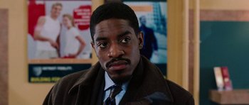 Movie still from “Four Brothers” (2005), directed by John Singleton – A person wearing a suit and tie; Close Up shot, Over the shoulder angle