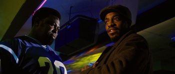 Movie still from “Four Brothers” (2005), directed by John Singleton – A couple of men standing next to each other in a room; Close Up shot, Low angle