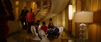 Movie still from “Four Brothers” (2005), directed by John Singleton – A group of people sitting around in a room; Wide shot, High angle