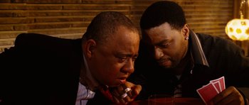 Movie still from “Four Brothers” (2005), directed by John Singleton – Two men sitting next to each other at a table; Close Up shot, Over the shoulder angle