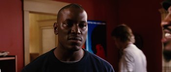 Movie still from “Four Brothers” (2005), directed by John Singleton – A person wearing a black t - shirt; Close Up shot, Over the shoulder angle