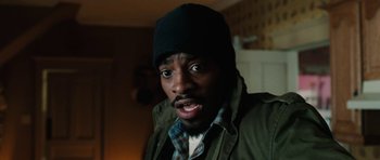 Movie still from “Four Brothers” (2005), directed by John Singleton – A person wearing a jacket and a hat; Close Up shot, High angle
