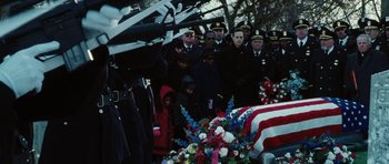 Movie still from “Four Brothers” (2005), directed by John Singleton – A group of people standing around a flag draped casket; Medium shot, High angle