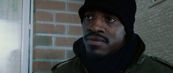 Movie still from “Four Brothers” (2005), directed by John Singleton – A person wearing a jacket and a hat; Close Up shot, Low angle