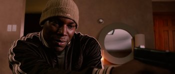 Movie still from “Four Brothers” (2005), directed by John Singleton – A person wearing a hat looking at a mirror; Close Up shot, High angle