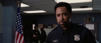 Movie still from “Four Brothers” (2005), directed by John Singleton – A man in a police uniform standing in an office; Close Up shot, Low angle