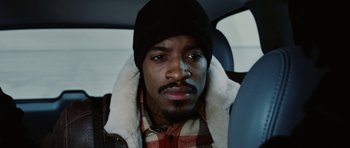Movie still from “Four Brothers” (2005), directed by John Singleton – A person in a car wearing a hat; Close Up shot, High angle
