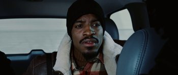 Movie still from “Four Brothers” (2005), directed by John Singleton – A person in a car wearing a hat; Close Up shot, High angle