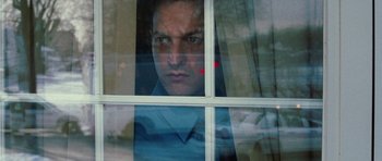Movie still from “Four Brothers” (2005), directed by John Singleton – A man looking out of a window at the camera; Close Up shot, Low angle