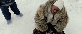 Movie still from “Four Brothers” (2005), directed by John Singleton – A man wearing a fur coat and a white hat; Medium shot, Overhead angle