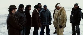 Movie still from “Four Brothers” (2005), directed by John Singleton – A group of people standing in the snow; Medium shot, Low angle