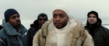 Movie still from “Four Brothers” (2005), directed by John Singleton – A man in a white hat and a man in a fur coat; Close Up shot, Low angle