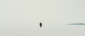 Movie still from “Four Brothers” (2005), directed by John Singleton – A man walking in the middle of a snow covered field; Extreme Wide shot, High angle