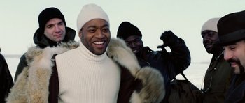 Movie still from “Four Brothers” (2005), directed by John Singleton – A man wearing a white sweater and a white hat; Medium shot, Low angle