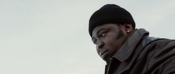 Movie still from “Four Brothers” (2005), directed by John Singleton – A person wearing a hat; Close Up shot, Low angle