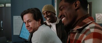 Movie still from “Four Brothers” (2005), directed by John Singleton – A group of men laughing together in front of a blue wall; Close Up shot, Over the shoulder angle