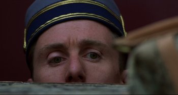Movie still from “Four Rooms” (1995), directed by Robert Rodriguez – A man's eyes as he looks over a wall; Close Up shot, Low angle