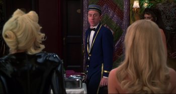 Movie still from “Four Rooms” (1995), directed by Robert Rodriguez – A man standing in front of a woman in front of a mirror; Medium shot, Over the shoulder angle