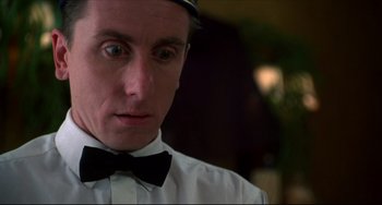 Movie still from “Four Rooms” (1995), directed by Robert Rodriguez – A person wearing a bow tie; Close Up shot, Low angle