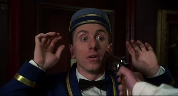 Movie still from “Four Rooms” (1995), directed by Robert Rodriguez – A person holding a pipe; Close Up shot, Low angle