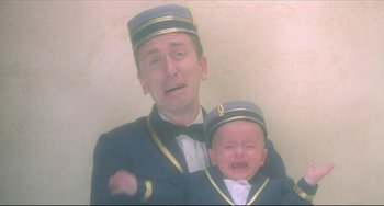 Movie still from “Four Rooms” (1995), directed by Robert Rodriguez – A man and a baby in uniform crying; Close Up shot, Low angle