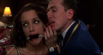 Movie still from “Four Rooms” (1995), directed by Robert Rodriguez – A man and a woman with their mouths taped shut; Close Up shot, Low angle