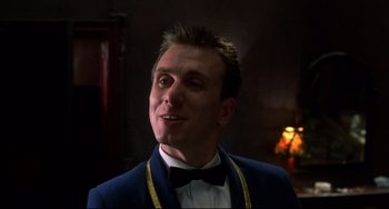 Movie still from “Four Rooms” (1995), directed by Robert Rodriguez – A person wearing a suit and bow tie; Close Up shot, Low angle