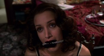 Movie still from “Four Rooms” (1995), directed by Robert Rodriguez – A woman is holding a toothbrush in her mouth; Close Up shot, High angle